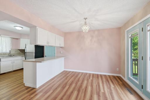 The dining room easily accommodates a large dining set, creating an ideal space for hosting and entertaining.
