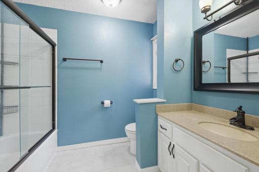 A full bathroom is situated on the upper level at the top of the stairs.