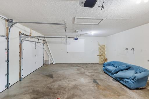 The garage includes two new doors, each equipped with a separate garage door opener.