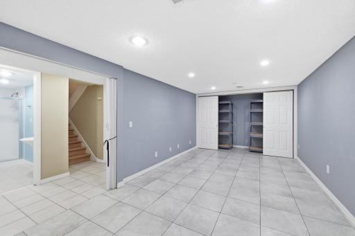 The durable, easy-to-clean tile flooring enhances the lower level, offering both style and practicality.