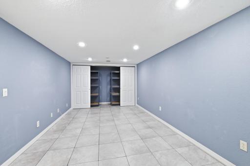 The durable, easy-to-clean tile flooring enhances the lower level, offering both style and practicality.