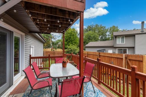 The deck off the dining room offers an ideal space for entertaining, and the patio set along with the outdoor carpet are included with the property.