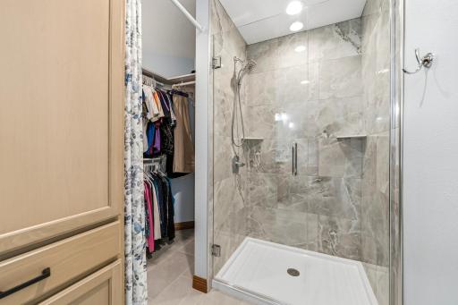 Owner's bathroom with tile shower and walk-in closet