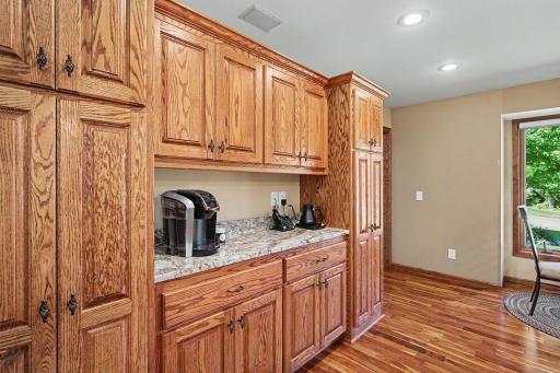 Kitchen features a coffee bar and a large pantry with cabinets.