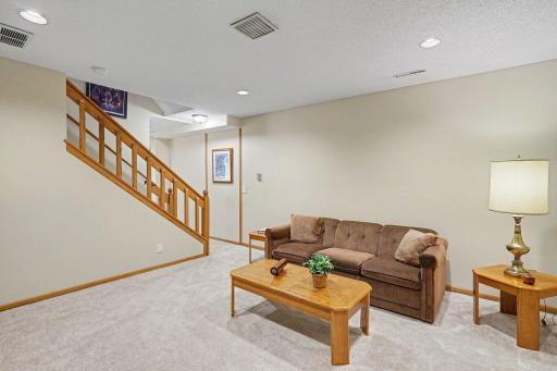 Spacious family room with recessed lighting and brand-new carpet.