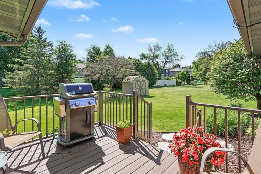 Newer composite deck with metal railing overlooking the backyard. Backyard also features a convenient storage shed perfect for outdoor projects and extra organization.