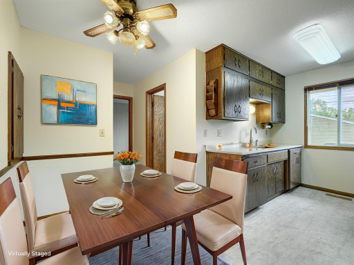 The eat-in kitchen has brand new LVP flooring and has a window overlooking the fenced backyard.