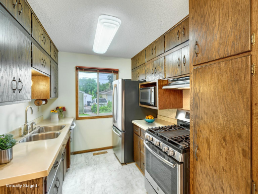 The kitchen has stainless appliances that stay with the home and the stove is gas.