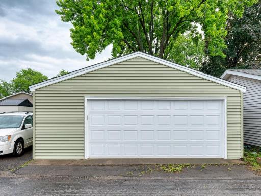 The detached garage in back is a 2.5 car with workbench that stays with home. There is also a carport next to it for extra parking.