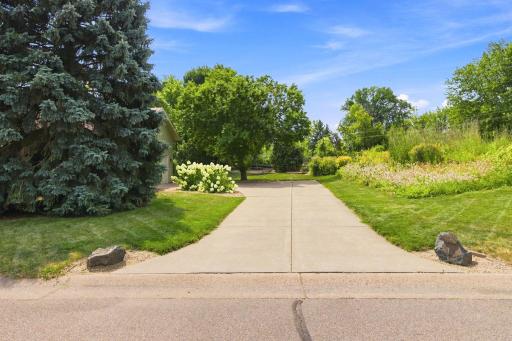 Gorgeous gardens, large concrete driveway and great curb appeal!