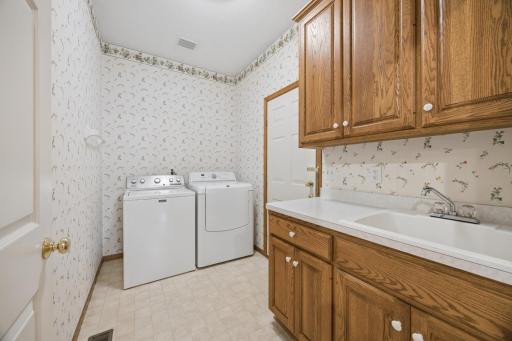 Main floor laundry with built in cabinetry.