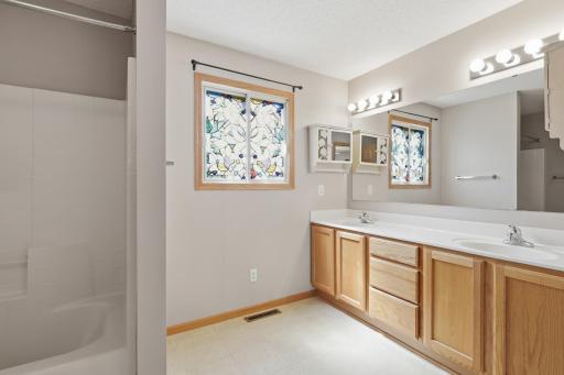 Shared upper floor bath with double vanity.