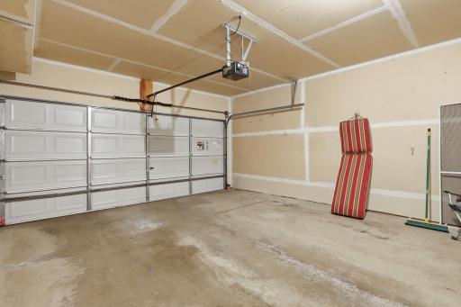 Two-stall attached garage with additional storage space or room for a workbench/potting bench.