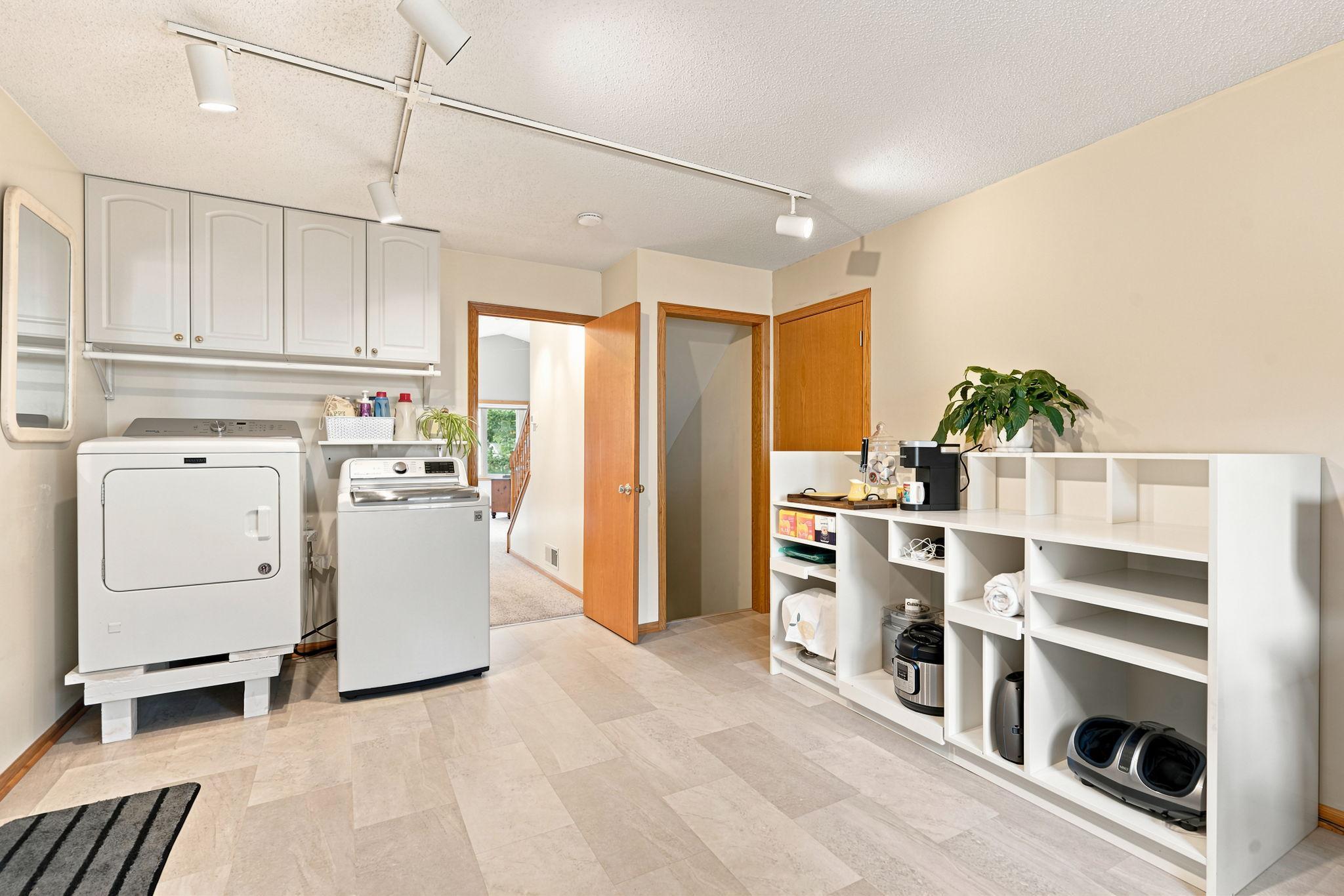 Back hall entry has laundry and coffee center and storage for large gadgets.