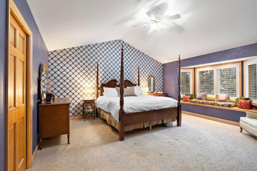 Primary suite has vaulted ceiling, bay window with window seat