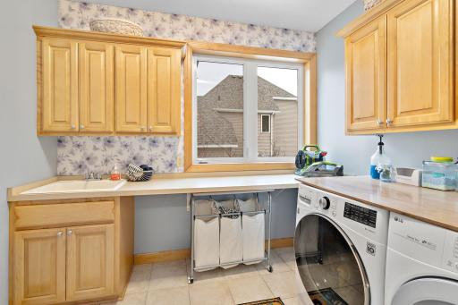 Large main floor laundry room with custom cabinets