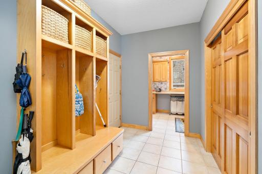 Oversized mudroom off the garage with custom built in lockers