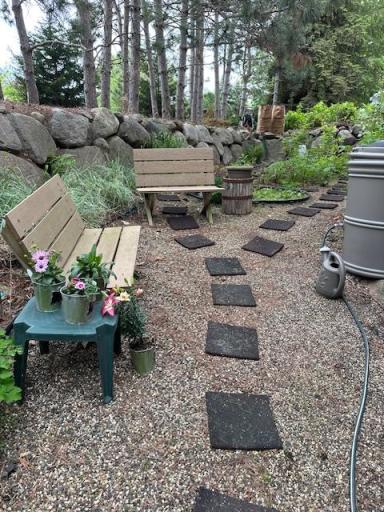 Side yard photo - sitting area - seller has beautiful gardens