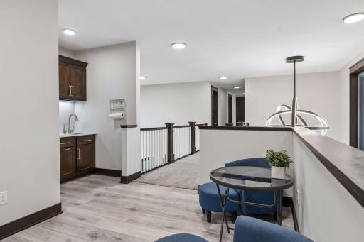 Snack kitchen which includes a sink and hot water dispenser.