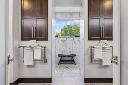 Towel warming rack on each side of the shower, each has an on/off on the bottom and a scheduling panel for each side, 5 ft quartz counter tops, Layered lighting – 5000k light temp available.