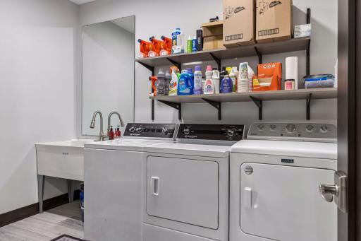 The laundry room has 2 dryers, access to the radiant in floor pipes in the games room and a large sink.