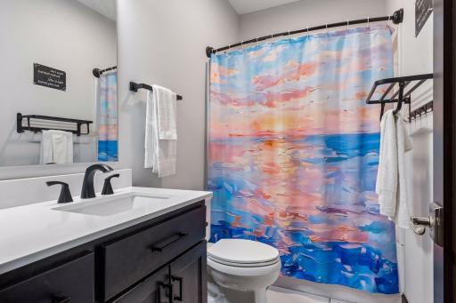 Quartz countertops, layered lighting in bathroom 3000k recessed light and 5000k lights above the mirror.