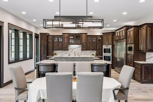 The back wall of the kitchen features a pantry, 2 dishwashers, sink, hot water dispenser, 2 appliance garages, pull-out garbage and recycling.