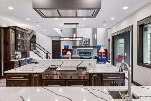 The baking island features a kitchen aid cabinet, lower cabinet storage that’s 3 ft deep and are accessible from either side of the island, bookcase and dog feeding/watering center