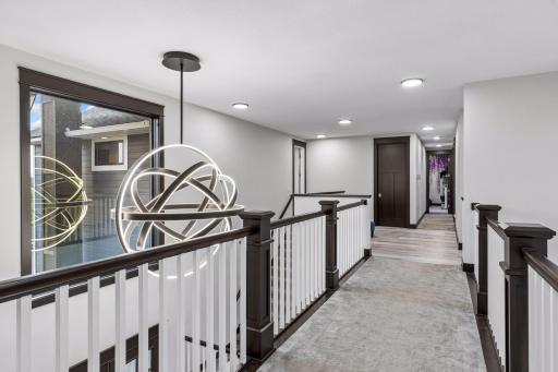 The catwalk connects the north and south wings of the home. The LED light is beautiful that hands over the foyer.