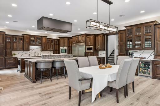 The dining room flows into a chef’s dream kitchen with 10-foot double islands.