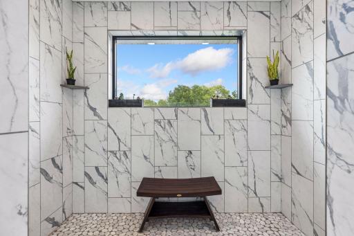 The primary shower provides Zero entry with 4 shower heads and a window overlooking the backyard.