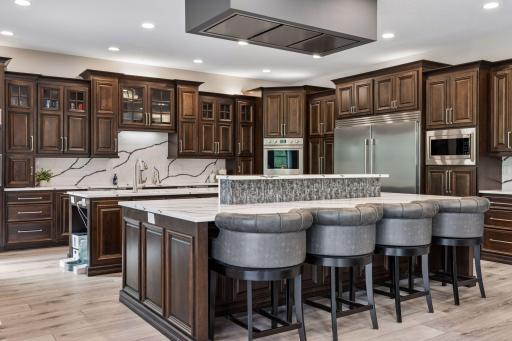 The first island (cooking island) also has a raised island; this allows for seating across from the cooktop and a place to set plates of cooked food as it becomes available.
