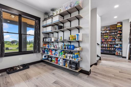This space is being used for kitchen overflow, drop zone needs, access to the 3-car garage and back staircase.  This is where the Sonos sound system for the dining room, kitchen, porch, and back deck lives. 