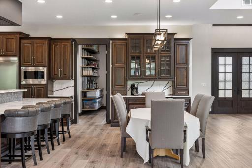 The dining space, which can easily accommodate a 10-foot table, has a modern chandelier and a built-in hutch with plenty of storage and a beverage fridge.  The hutch includes a pull-out garbage on one side and on the other side for easy access.