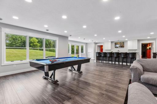 Recreation space including a pool table, kitchenette with double doors leading to the back patio. 