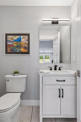Half bath outside kitchenette and theater for disposing of the soda washing down the popcorn!