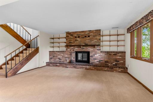 The lower level family room with a wood burning fireplace.