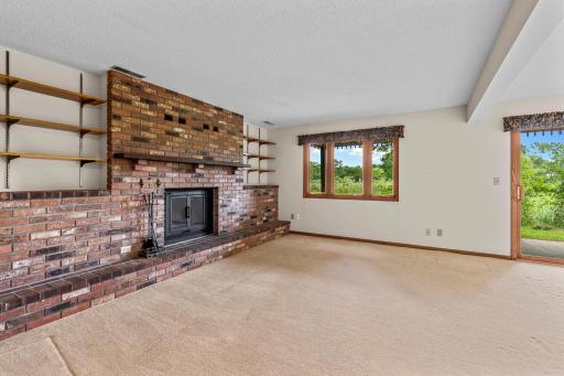 The lower level family room with a wood burning fireplace. Great views!
