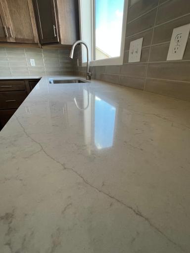 Quartz countertops and tile backsplash
