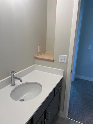 Shelf tucked away in hall bath for additional storage