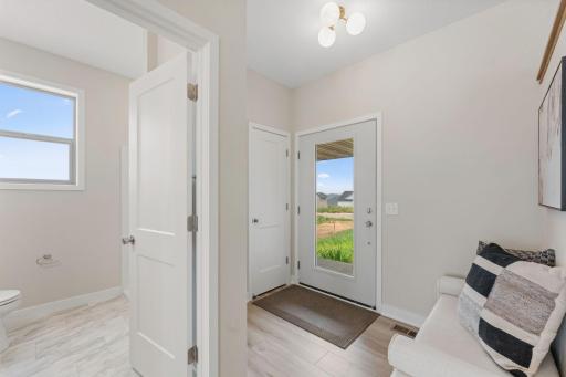 Full glass door flooding in light to the foyer