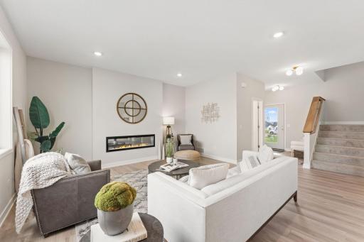 Continuous flooring in foyer, family room, eating area, and kitchen
