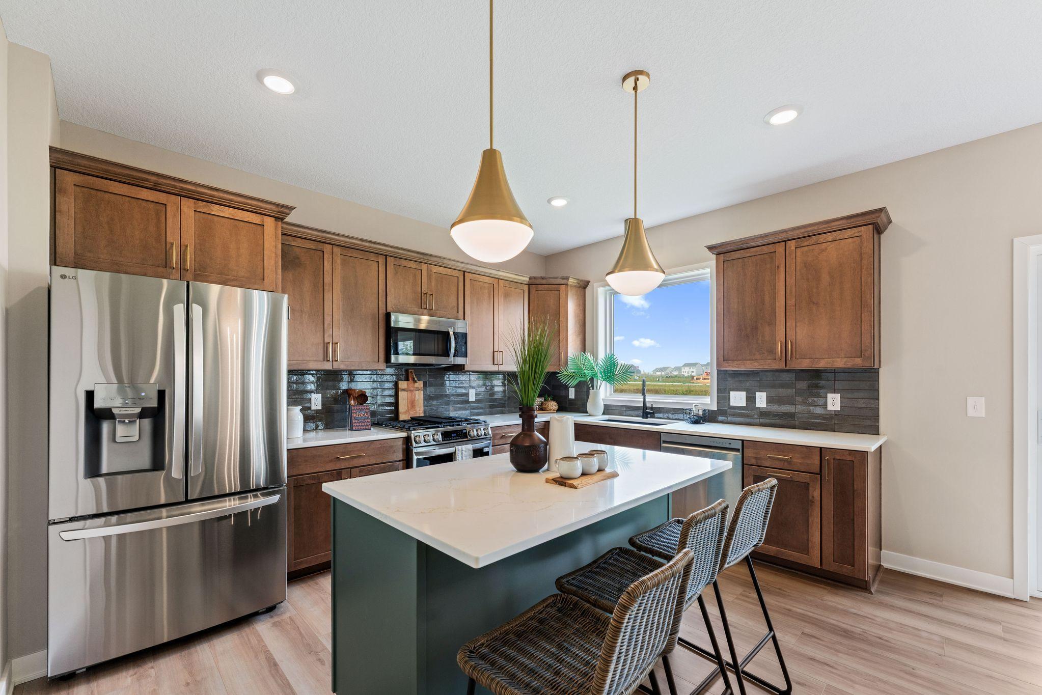 Wood perimeter cabinets with Quartz countertops and tile backsplash