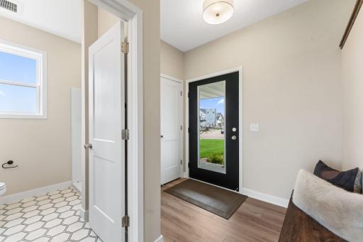 Foyer with full glass front door flooding light into the home