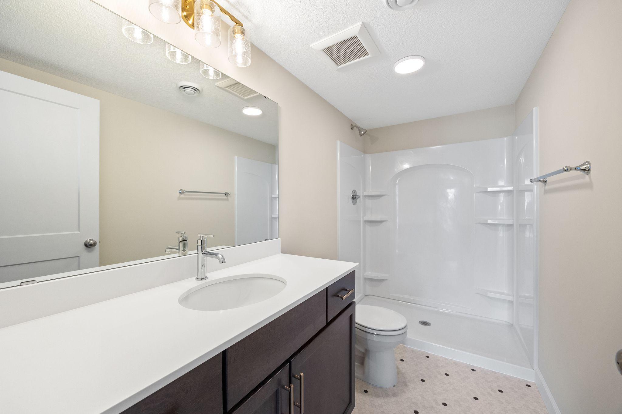 Bathroom in lower level - this photo is not this exact home, but one of the same floorplan