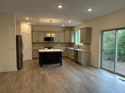 Open floorplan with kitchen overlooking eating area and family room