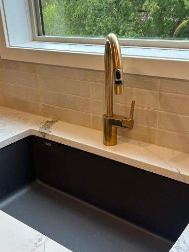 Brushed gold accents in the kitchen with faucet