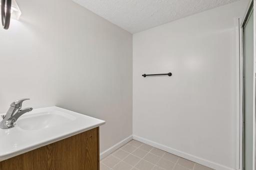 The large lower level 3/4 bath has additional space for a linen cabinet or makeup table