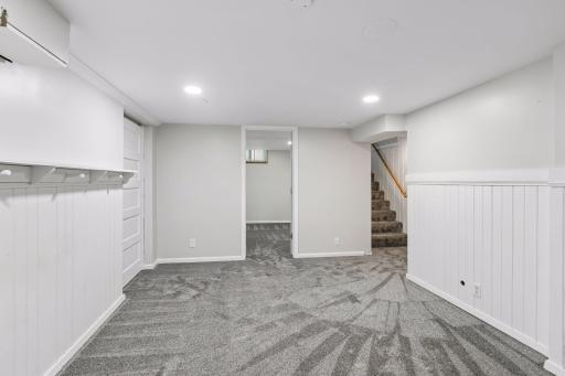 This room is accentuated with white paneling and a decorative display shelf