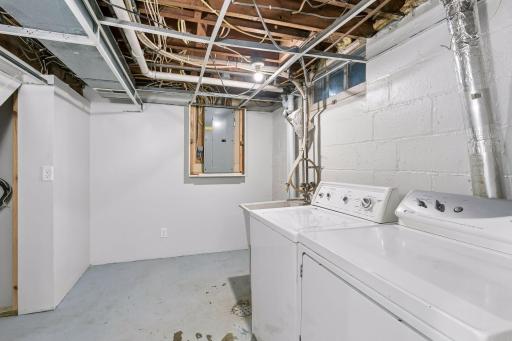 The bright and cheery laundry room has a laundry tub and space to fold clothes